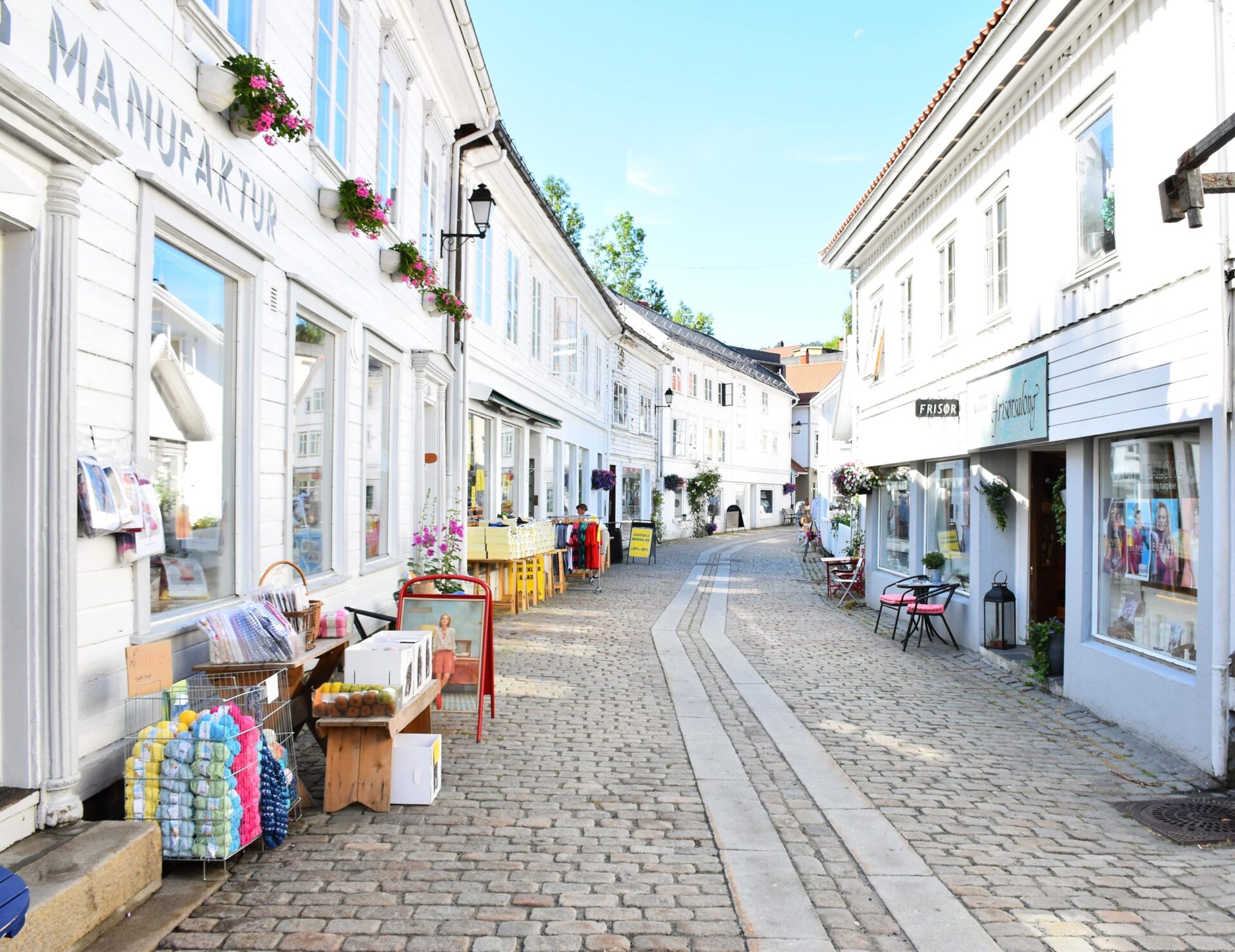 Stroll through narrow streets lined with white wooden houses in Southern Norway